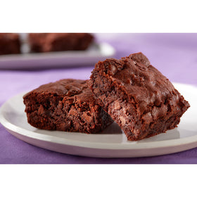 HERSHEY'S unsweetened cocoa powder sifted into frosting for a glossy glaze