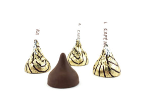 Hershey's Kisses Espresso close-up on gold foil, inviting cafe mocha aroma