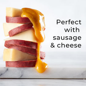 Hickory Farms Honey Pineapple Mustard on a charcuterie board with meats and cheese.