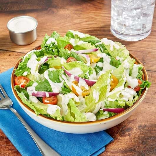 Close-up of Hidden Valley Ranch dipping cup, ready to pour on salads or wings.