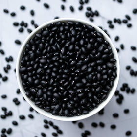 High Plains Beans cooked with aromatics in a pot, showcasing plant-based protein.