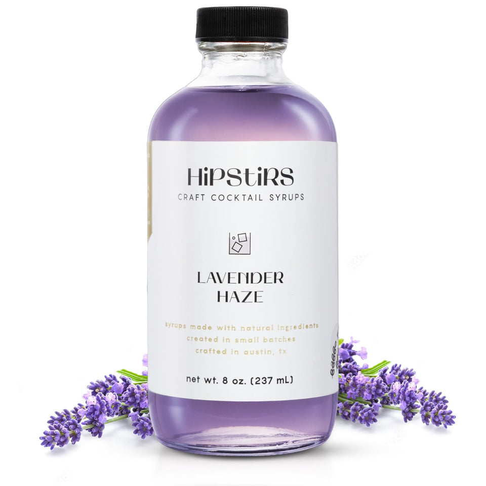 HipStirs Lavender Haze Syrup bottle on wood highlights premium ingredients for craft cocktails.