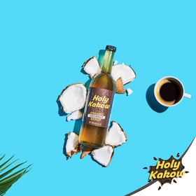 Holy Kakow Coconut Syrup dispensing glass ready for sweetened beverages.