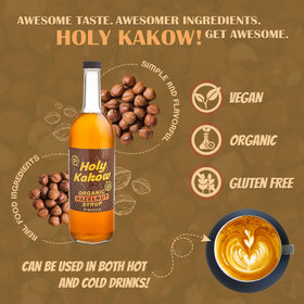 Holy Kakow hazelnut syrup being poured suggests versatile use in lattes and desserts.