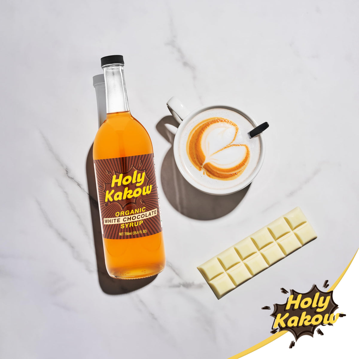 Holy Kakow White Chocolate Syrup on kitchen counter enhances drinks and desserts.