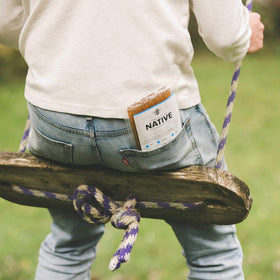 Homestead Honey Native Sticks in a backpack for convenient energy during a hike.