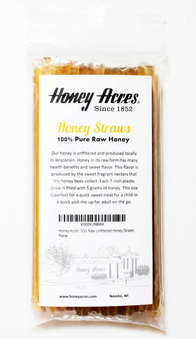 Hand holding a Honey Acres honey straw, highlighting convenient, ready-to-eat sweetness.