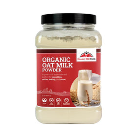 Hoosier Hill Farm Organic Oat Milk Powder bottle pour showing creamy texture and dairy-free appeal.