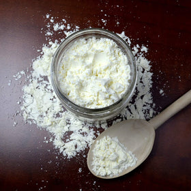 Scooping Hoosier Hill Farm Whole Milk Powder for smoothies and baking.
