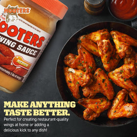 THE ORIGINAL HOOTERS Hooters Original Medium Wing Sauce glaze on wings for a glossy finish.