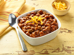 HORMEL Natural Chili with Beans used as a dip or topping for hot dogs.