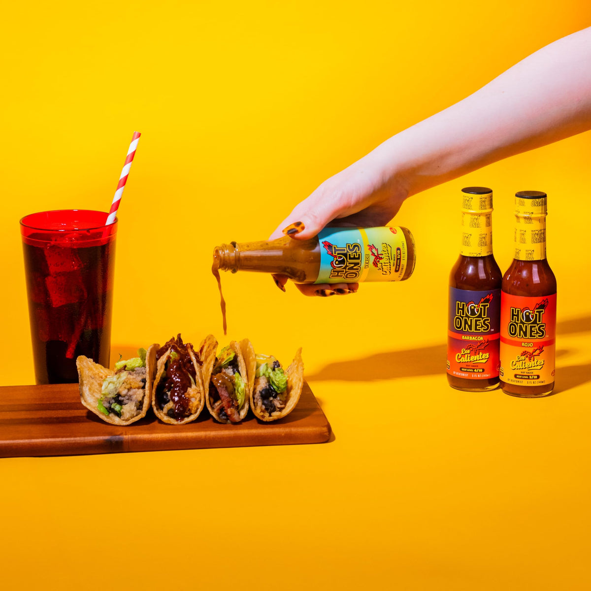 Hot Ones Caliente Trio Barbecue bottle pour—smoky depth that pairs with grilled meats.