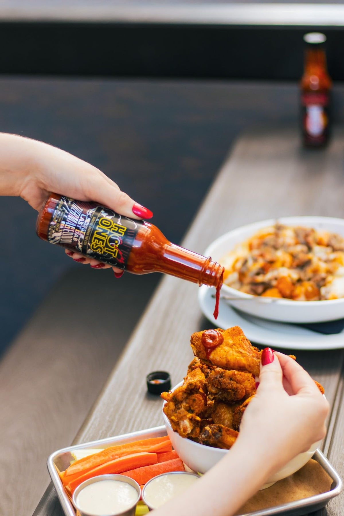 Hot Ones Da Bomb Evolution bottle pour rocks wings with fearless heat