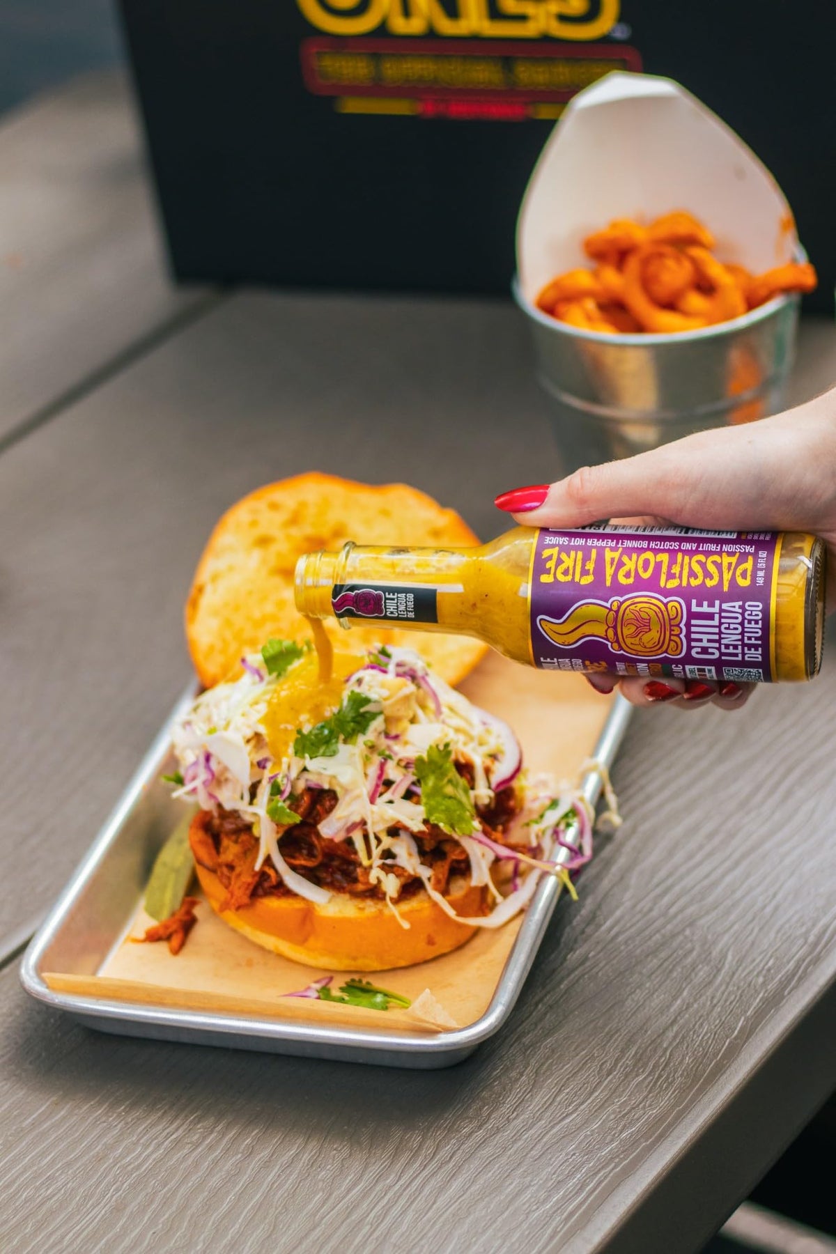 Hot Ones Hawaiian HotTs POG bottle pour delivers island fruit kick for burgers