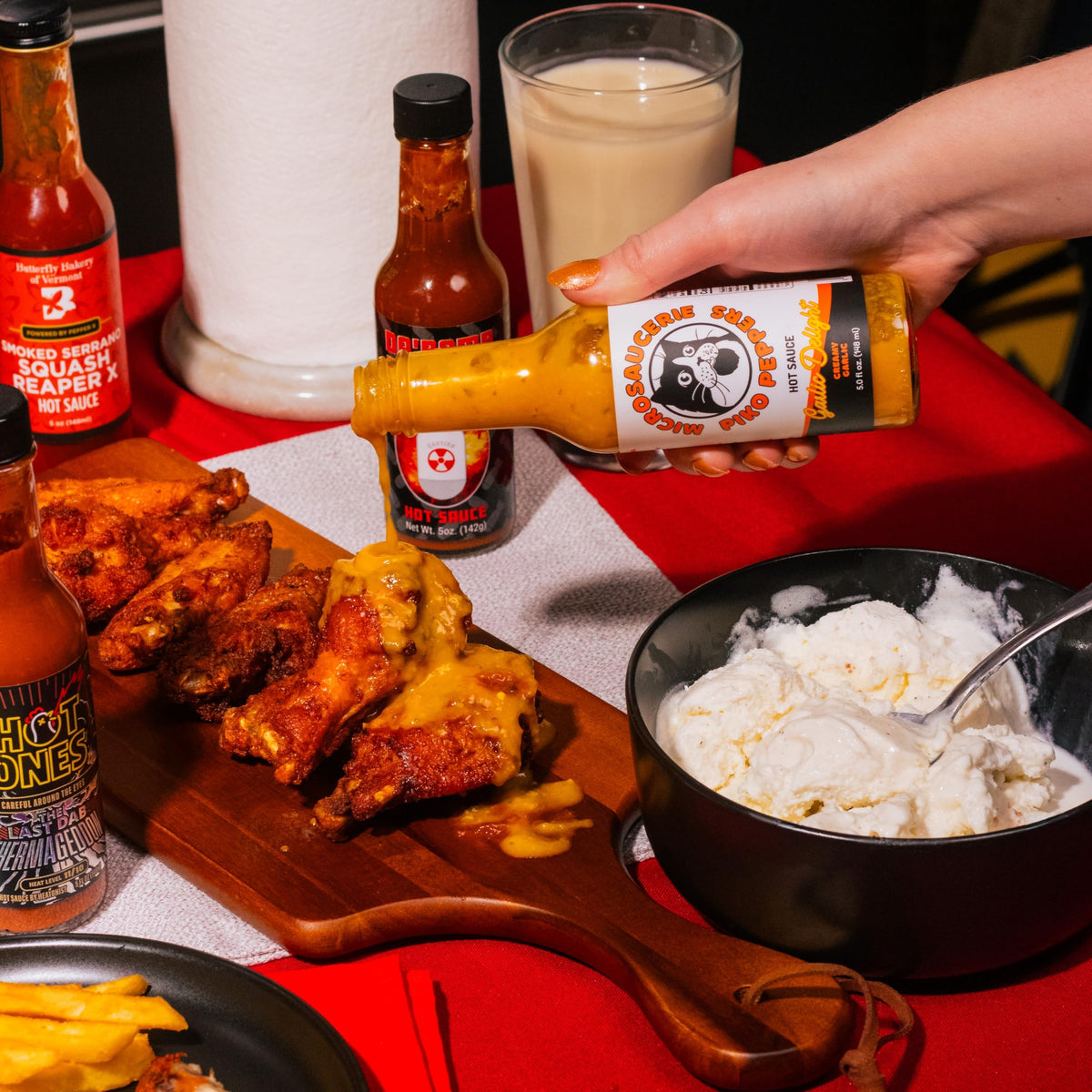 HOT ONES Season 29 wings dipping scene demonstrates versatile sauces.