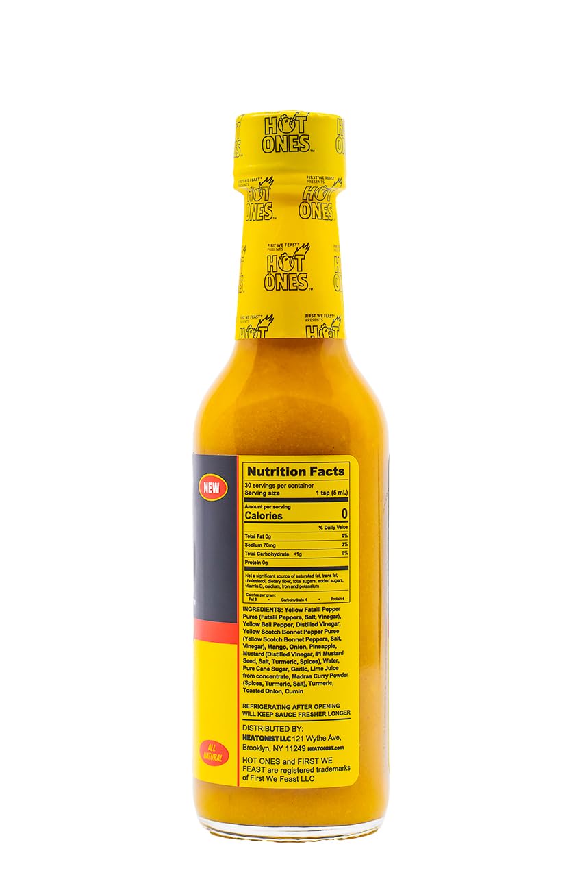 Sizzling dish topped with Hot Ones Tropical Amarillo sauce highlighting island-inspired heat.