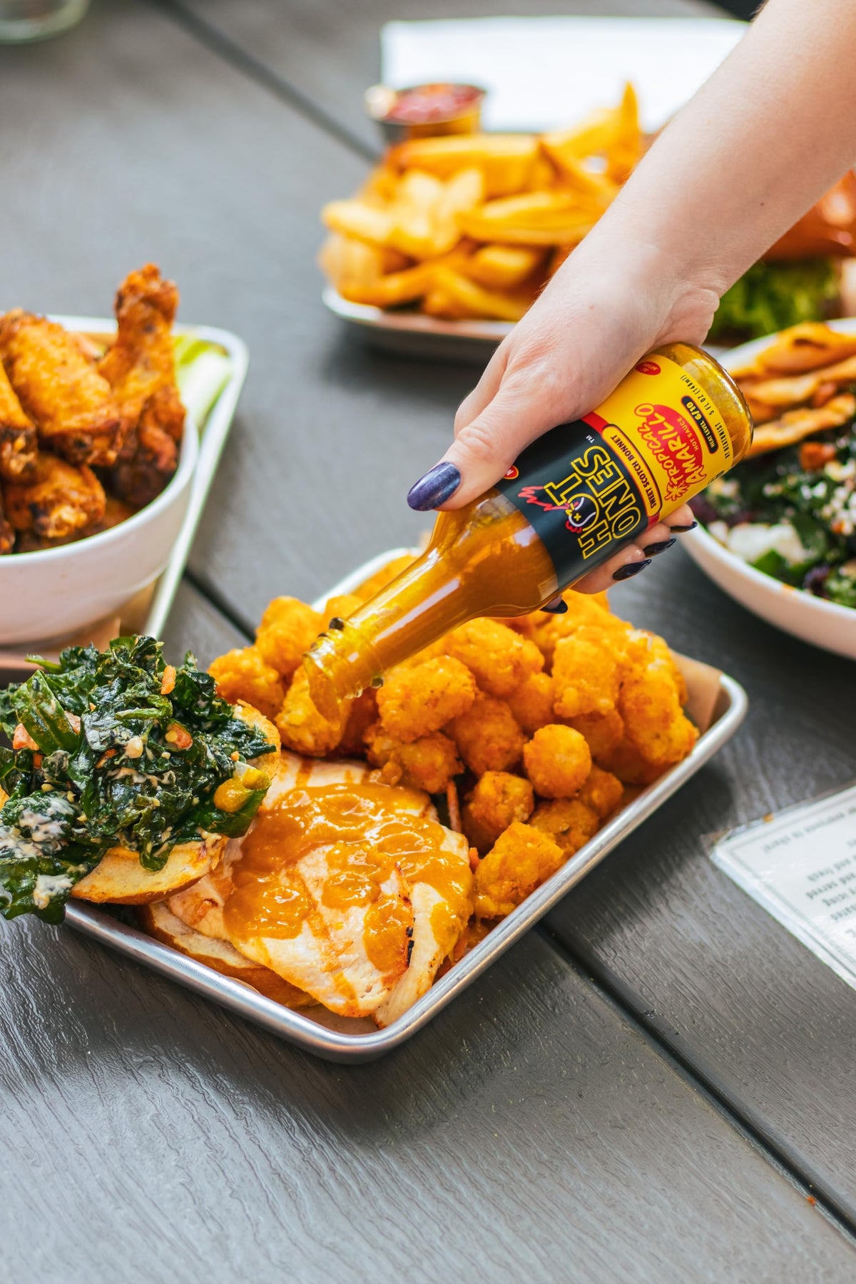 Hot Ones label close-up with anniversary branding and Caribbean-inspired flavor profile.