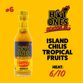 Hot Ones Tropical Amarillo bottle being poured, releasing tropical citrus warmth for dishes.