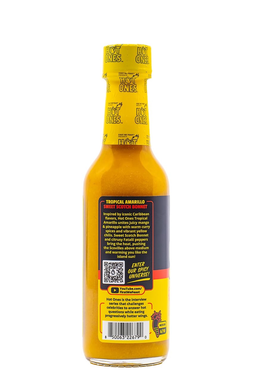 Sauce bottle beside citrus fruits signaling tropical pairing ideas for bowls and meats.