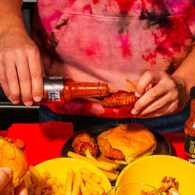 Hot Ones variety flavors bottles stand conveys diverse heat profiles for experimentation