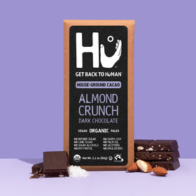 Hu Almond Crunch in-hand shot suggests convenient snack anywhere, anytime
