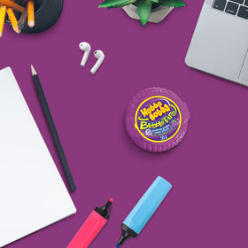 Hubba Bubba Bubble Tape box with twelve rolls on shelf for family use.