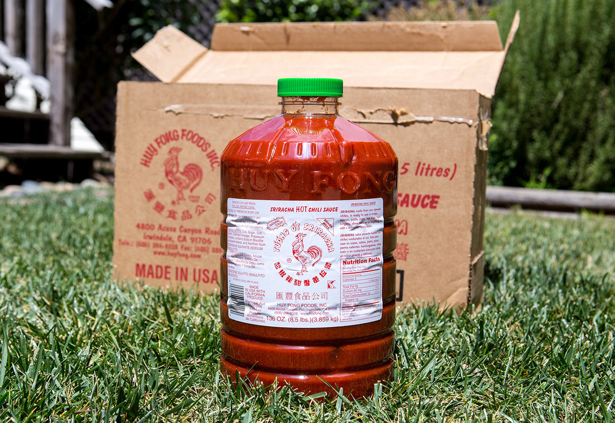 Huy Fong Sriracha bottle closeup showing bright red chili sauce