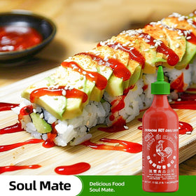 Glass bottle of Huy Fong Sriracha with bright red color and recognizable branding.