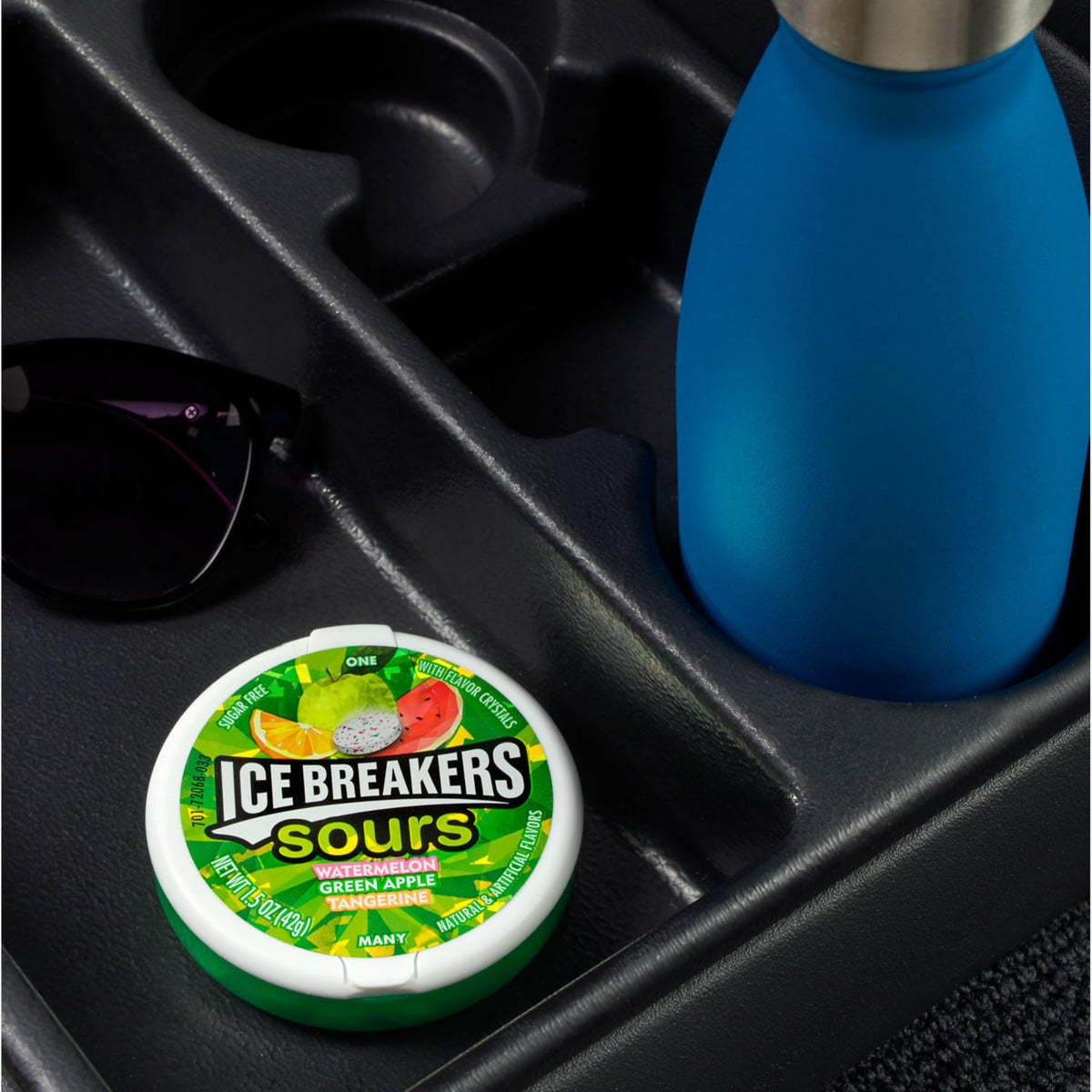 Ice Breakers Sours dispense action captures dual-sided puck design for sharing.