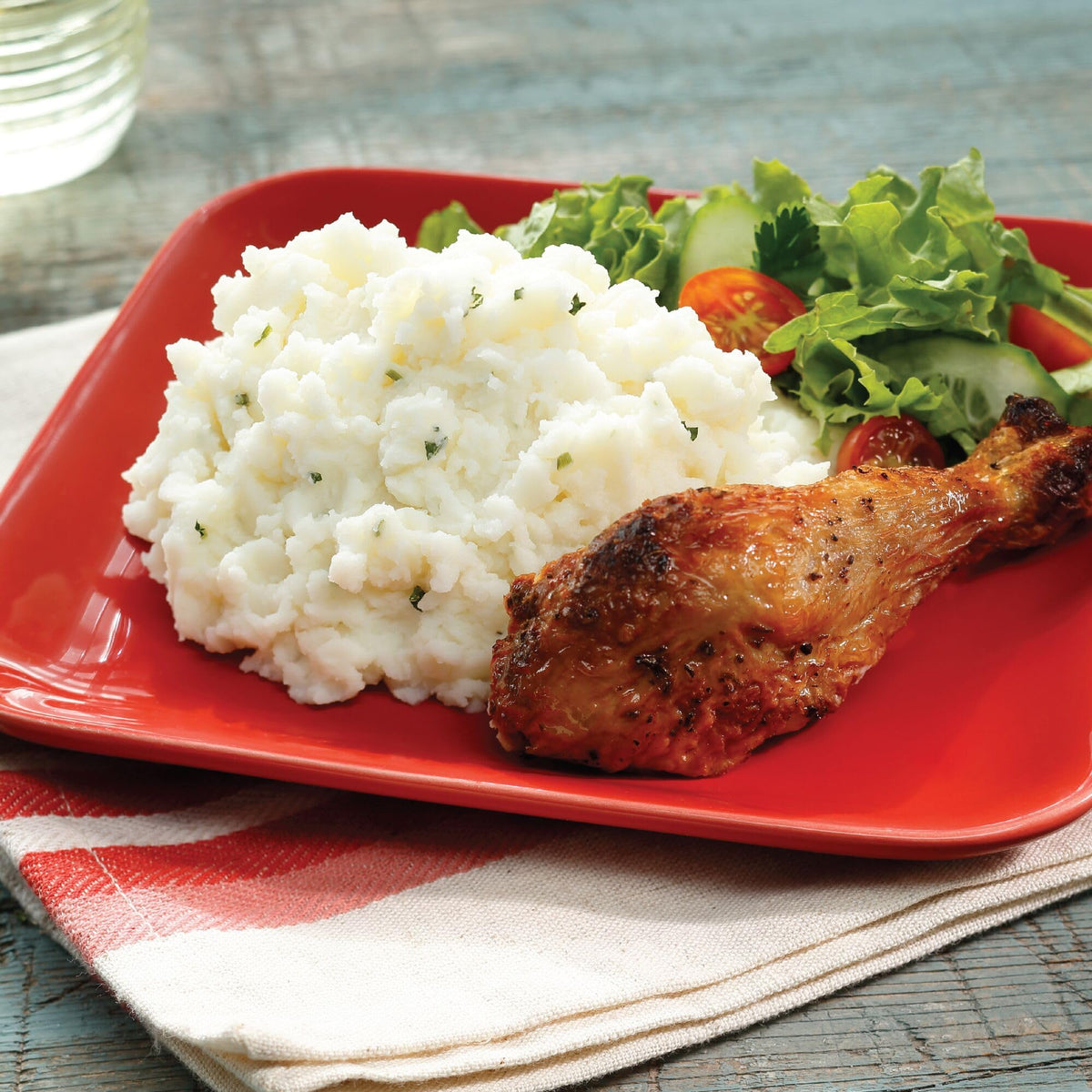 Serving with meat and vegetables alongside creamy Idahoan mashed potatoes