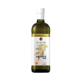 Iliada Kalamata PDO olive oil bottle on kitchen counter, ideal for finishing dishes with fresh flavor.