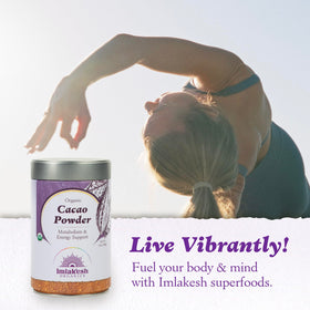 Imlak'esh Organics cacao powder in spoon over smoothie for a chocolate boost.