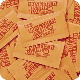 IN THE RAW Monk Fruit Packets dispensing into cup demonstrates easy zero-calorie sweetening.