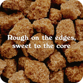 Closeup of In The Raw Turbinado sugar cubes showing golden crystals.