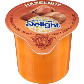 Shelf-stable non-dairy creamer packaging by International Delight for office or travel.