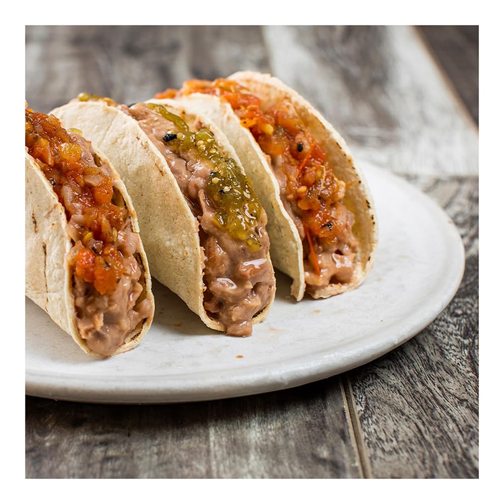 Isadora served pinto beans in a bowl, ideal for toppings or sides