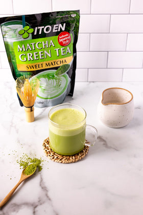 Ito En Matcha Sweet Powder scoop over a latte with creamy texture.