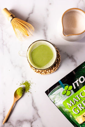 Ito En Matcha Sweet Powder being poured into a glass for a refreshing iced latte.