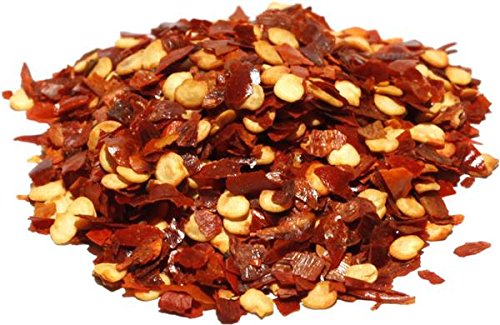 It's Delish crushed chilies flakes closeup highlights vibrant red color and bold flavor.
