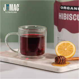 J Mac Botanicals hibiscus flowers close-up showing vibrant ruby petals.