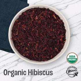J Mac Botanicals hibiscus tea infusion in hot water with rich color.