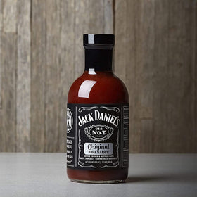 Jack Daniel's sauce bottle pour, smooth glaze ideal for brushed BBQ dishes.