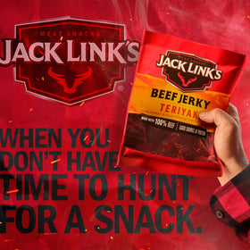 Jack Link's Teriyaki Jerky in a car cup holder, convenient highway snack.