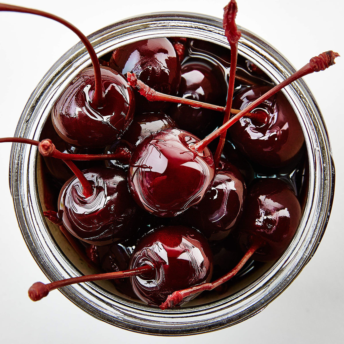 Jar closeup of tart Oregon cherries ready to garnish Old Fashioned