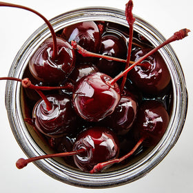 Jar closeup of tart Oregon cherries ready to garnish Old Fashioned