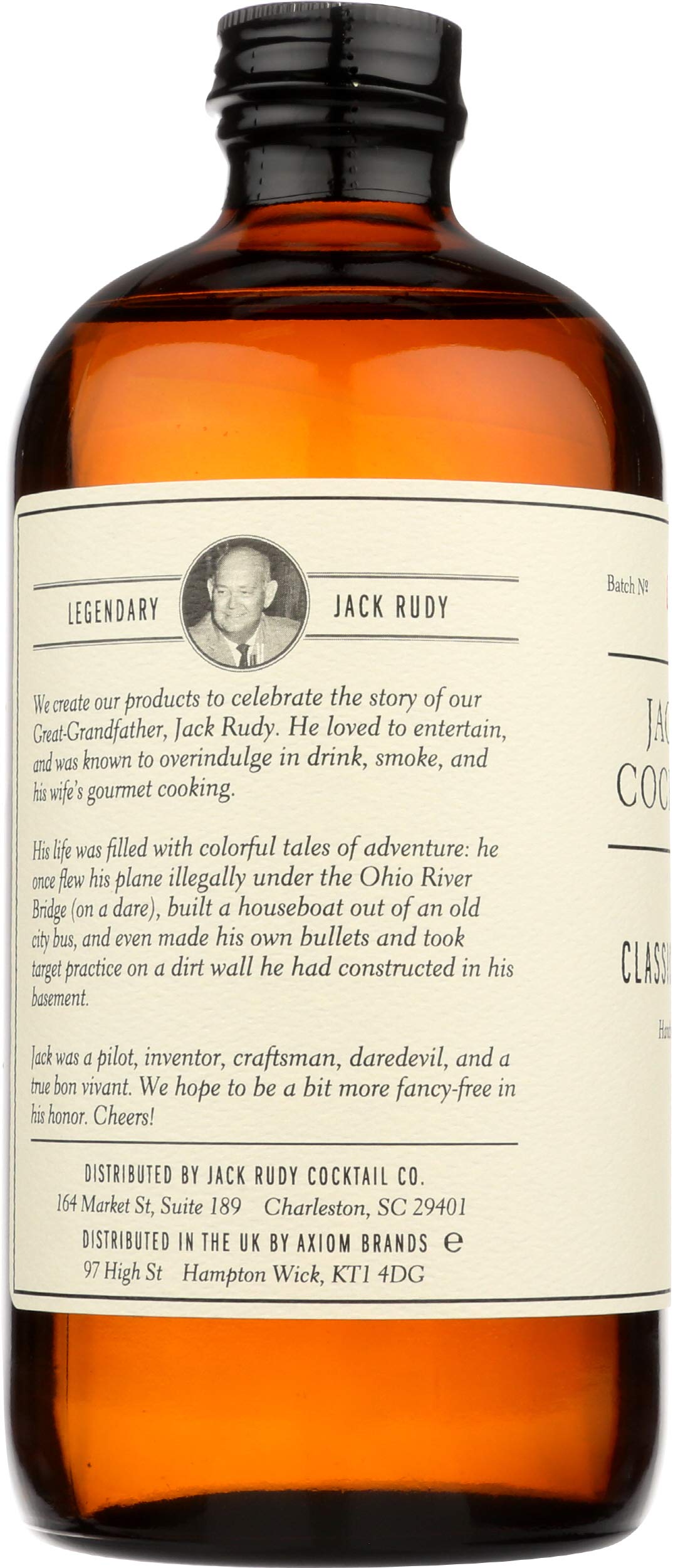 Jack Rudy tonic bottle with botanical ingredients visible behind the label
