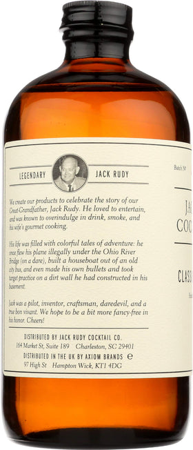 Jack Rudy tonic bottle with botanical ingredients visible behind the label