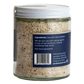 Close-up of coarse salt crystals and Tellicherry pepper for depth and brightness.