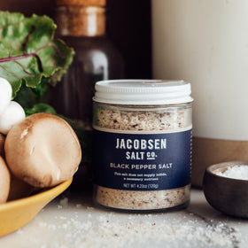 Pouring Jacobsen Black Pepper Salt to season steak or chicken.