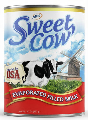Pour Jans Sweet Cow evaporated milk into a measuring cup for creamy recipes
